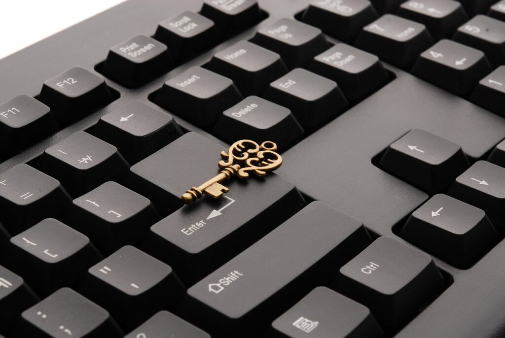 Gold key resting on a computer keyboard symbolizing a key to business success