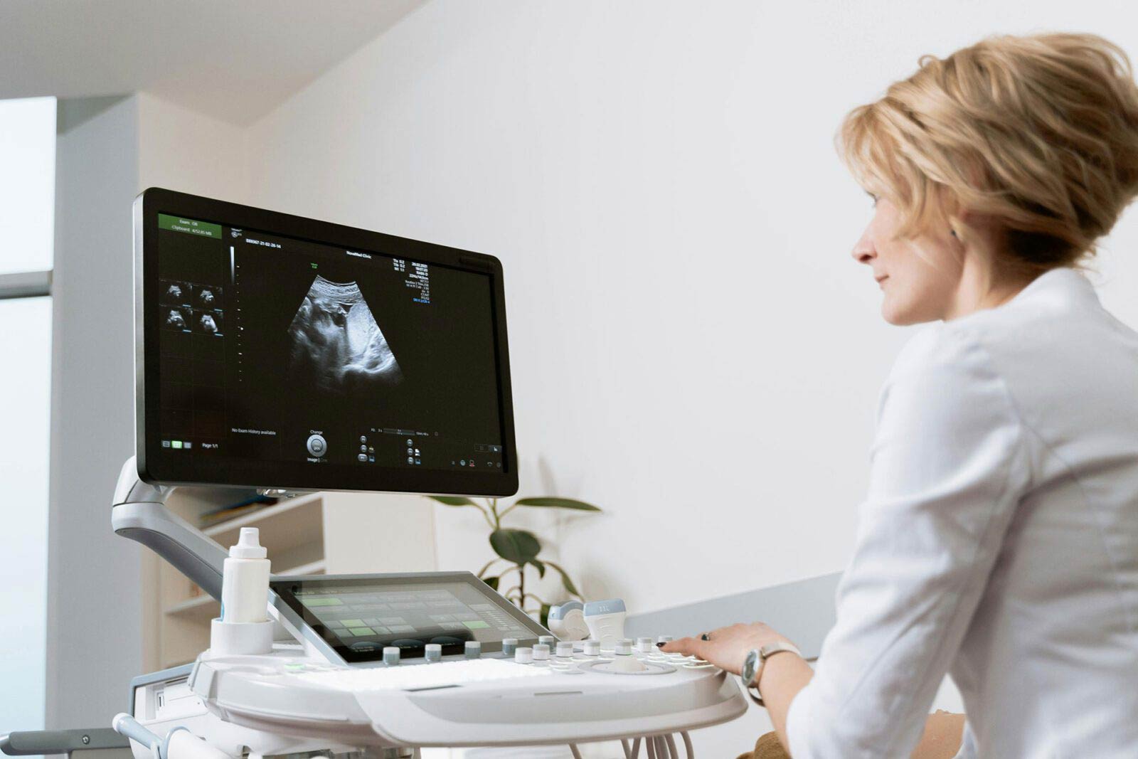 A doctor looking at a patient’s sonogram on a computer monitor.